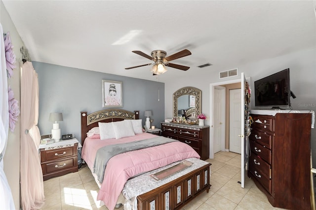 bedroom featuring light tile patterned floors, visible vents, and a ceiling fan