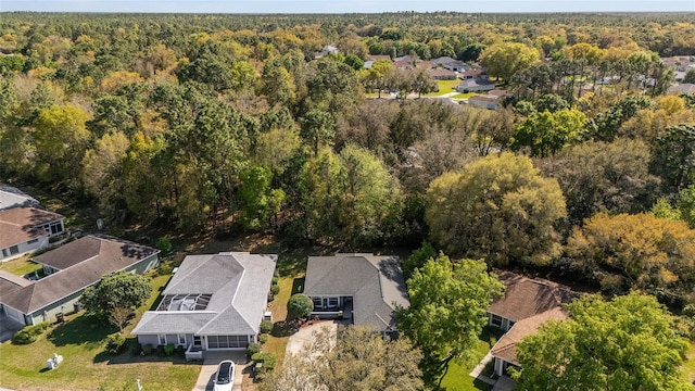 drone / aerial view with a residential view and a wooded view