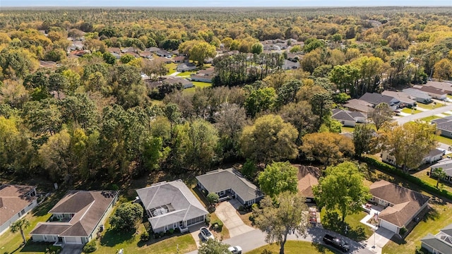 drone / aerial view featuring a view of trees and a residential view