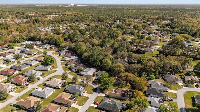 drone / aerial view featuring a view of trees and a residential view