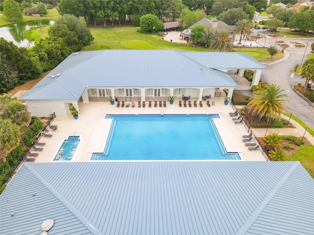 community pool featuring a patio and a water view