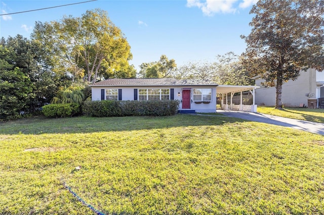 ranch-style house with an attached carport, concrete driveway, and a front yard