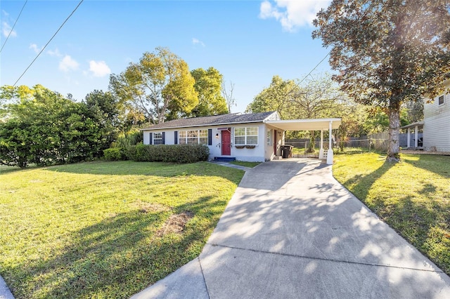 view of front of property with a carport, concrete driveway, fence, and a front lawn