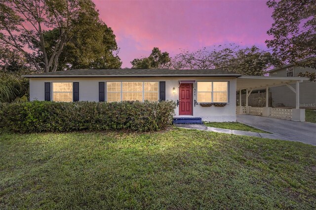 829 NE 15th Ave, Ocala, FL 34470 - ranch-style home with an attached carport, concrete driveway, and a yard