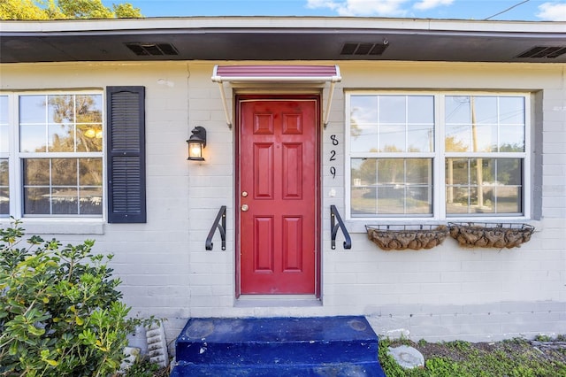 829 NE 15th Ave, Ocala, FL 34470 - doorway to property featuring concrete block siding and visible vents