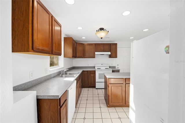 829 NE 15th Ave, Ocala, FL 34470 - kitchen featuring brown cabinets, a sink, under cabinet range hood, recessed lighting, and white appliances