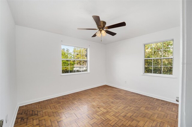 829 NE 15th Ave, Ocala, FL 34470 - unfurnished room with plenty of natural light, a ceiling fan, and baseboards
