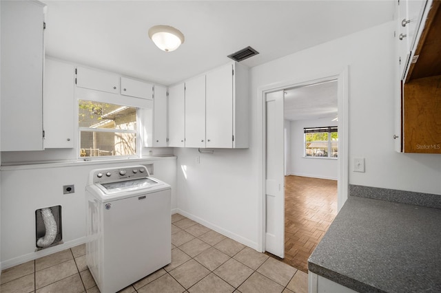 829 NE 15th Ave, Ocala, FL 34470 - washroom with light tile patterned flooring, washer / dryer, cabinet space, and baseboards