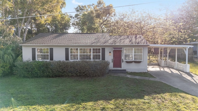 829 NE 15th Ave, Ocala, FL 34470 - view of front of home with an attached carport, a front lawn, concrete driveway, and stucco siding