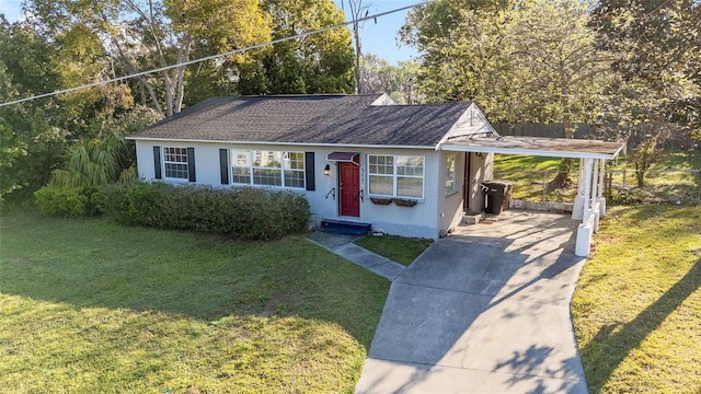 829 NE 15th Ave, Ocala, FL 34470 - view of front of property with entry steps, concrete driveway, a front yard, a shingled roof, and an attached carport