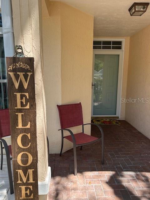 entrance to property with stucco siding