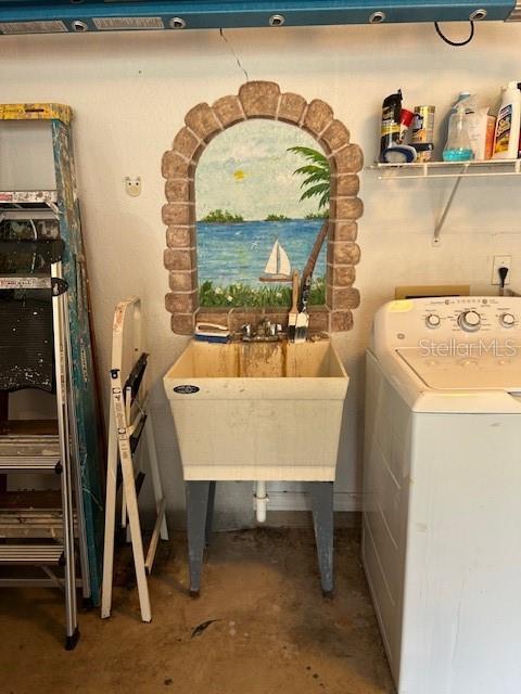 laundry area featuring washer / clothes dryer, laundry area, and a sink