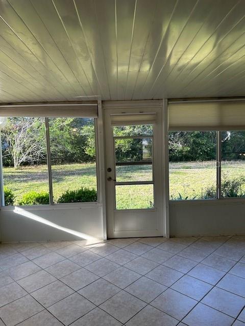 unfurnished sunroom with plenty of natural light