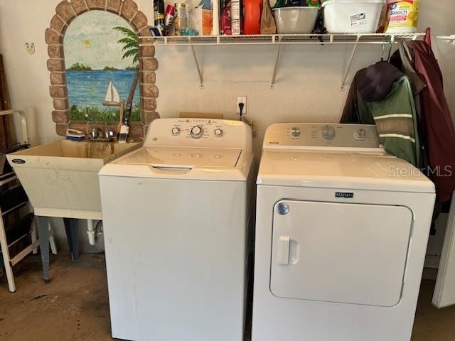laundry area with a sink, independent washer and dryer, and laundry area
