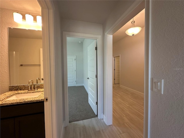 4528 SW 90th Lane Rd, Ocala, FL 34476 - hallway with a sink, light wood finished floors, and a textured wall