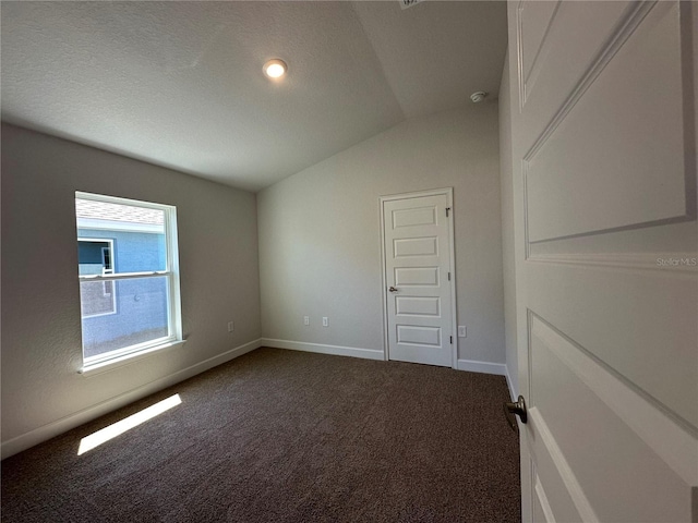 4528 SW 90th Lane Rd, Ocala, FL 34476 - unfurnished room with vaulted ceiling, dark colored carpet, and baseboards