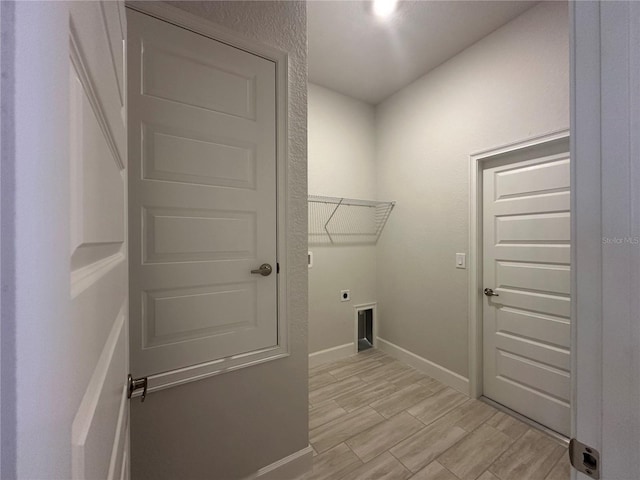 4528 SW 90th Lane Rd, Ocala, FL 34476 - washroom with electric dryer hookup, baseboards, and light wood finished floors