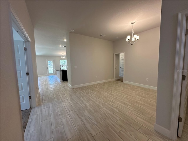 4528 SW 90th Lane Rd, Ocala, FL 34476 - spare room featuring a chandelier, baseboards, and light wood-type flooring