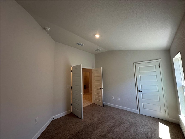 4528 SW 90th Lane Rd, Ocala, FL 34476 - unfurnished bedroom with vaulted ceiling, carpet flooring, baseboards, and a textured ceiling