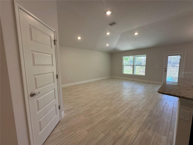 4528 SW 90th Lane Rd, Ocala, FL 34476 - unfurnished room featuring baseboards, light wood-style flooring, recessed lighting, a textured ceiling, and lofted ceiling