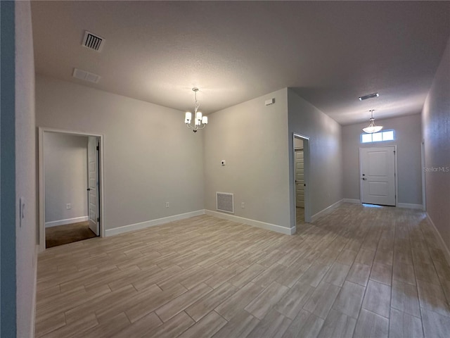 4528 SW 90th Lane Rd, Ocala, FL 34476 - spare room featuring a chandelier, light wood-style flooring, and baseboards