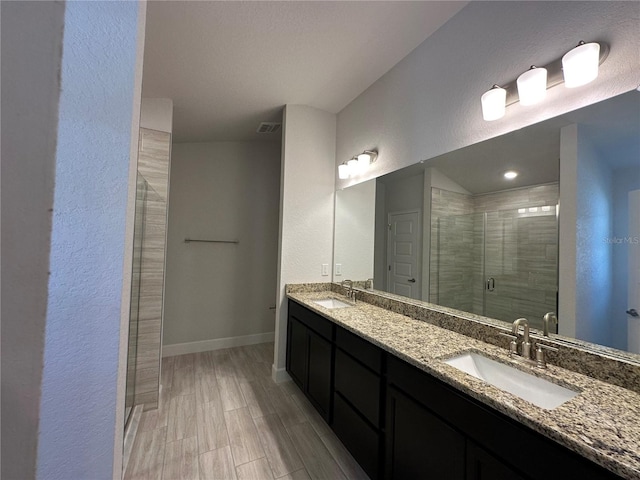 4528 SW 90th Lane Rd, Ocala, FL 34476 - full bathroom featuring double vanity, a stall shower, baseboards, and a textured wall