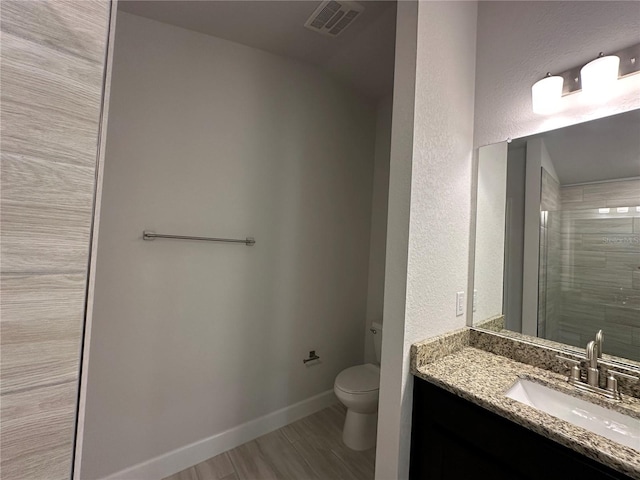4528 SW 90th Lane Rd, Ocala, FL 34476 - full bathroom with toilet, vanity, wood finished floors, baseboards, and a tile shower