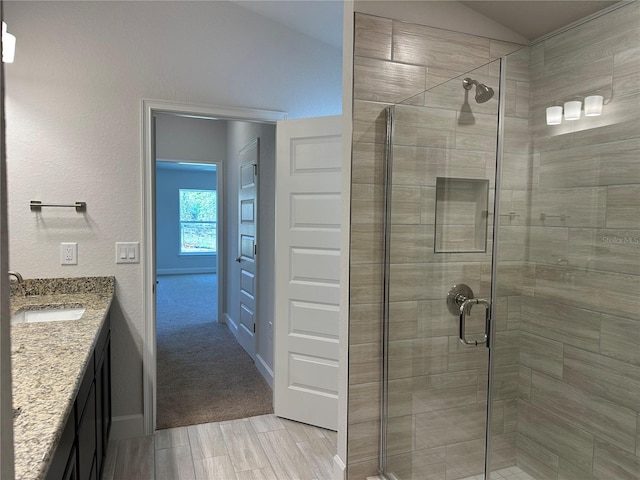 4528 SW 90th Lane Rd, Ocala, FL 34476 - full bathroom featuring a stall shower, vaulted ceiling, vanity, and baseboards