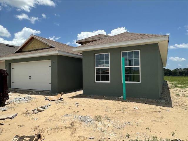 4528 SW 90th Lane Rd, Ocala, FL 34476 - view of front of home with a garage, stucco siding, and a shingled roof