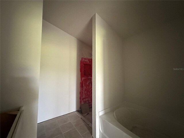 4528 SW 90th Lane Rd, Ocala, FL 34476 - bathroom with a garden tub and tile patterned flooring