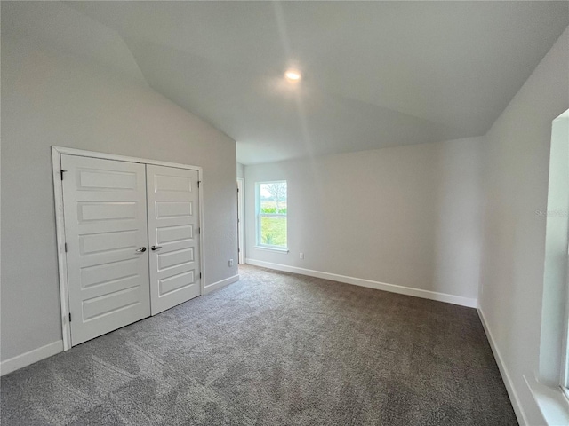 4498 SW 90th Lane Rd, Ocala, FL 34476 - unfurnished bedroom with lofted ceiling, carpet floors, baseboards, and a closet