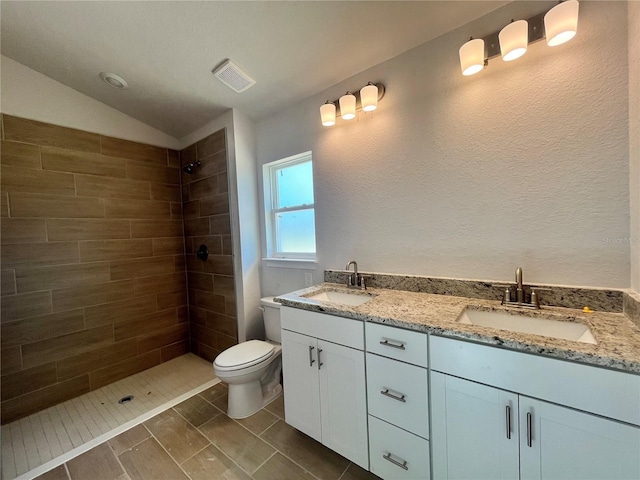 4498 SW 90th Lane Rd, Ocala, FL 34476 - bathroom with double vanity, tiled shower, lofted ceiling, and a textured wall