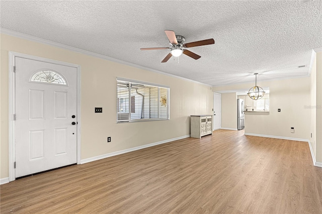 10980 SW 62nd Avenue Rd, Ocala, FL 34476 - entryway featuring light wood finished floors, ceiling fan with notable chandelier, a textured ceiling, and crown molding