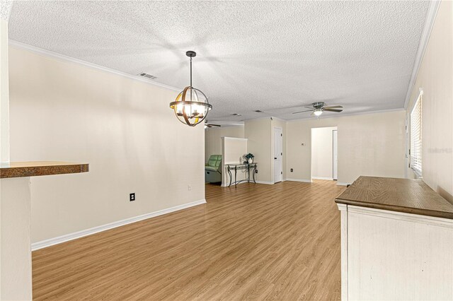 10980 SW 62nd Avenue Rd, Ocala, FL 34476 - unfurnished living room with visible vents, ornamental molding, ceiling fan with notable chandelier, a textured ceiling, and light wood-style floors