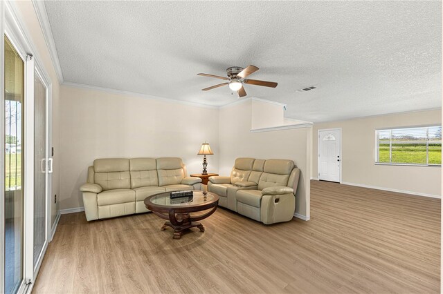 10980 SW 62nd Avenue Rd, Ocala, FL 34476 - living area featuring visible vents, baseboards, ornamental molding, wood finished floors, and a ceiling fan