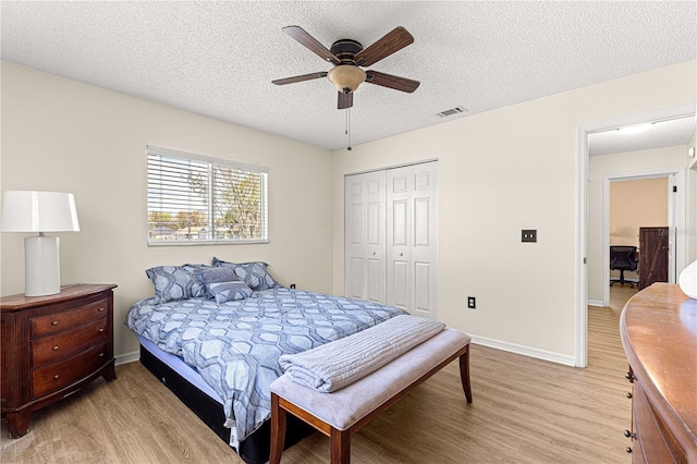 10980 SW 62nd Avenue Rd, Ocala, FL 34476 - bedroom with baseboards, visible vents, light wood-style floors, a closet, and a textured ceiling