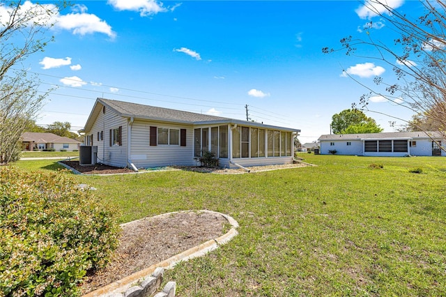 10980 SW 62nd Avenue Rd, Ocala, FL 34476 - rear view of property featuring central air condition unit, a yard, and a sunroom