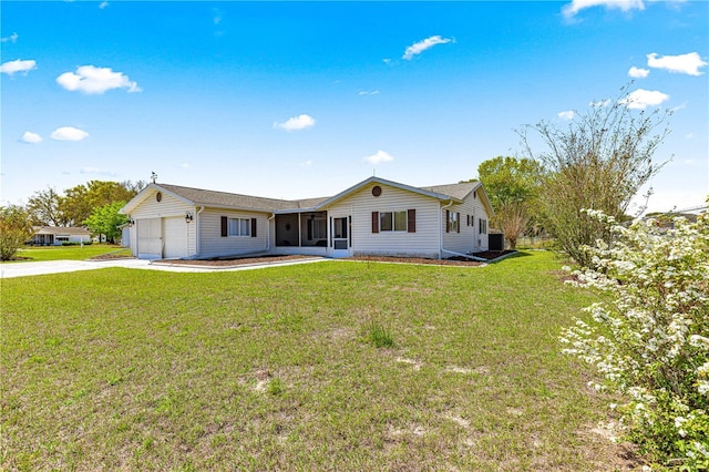 10980 SW 62nd Avenue Rd, Ocala, FL 34476 - rear view of property featuring concrete driveway, a yard, a garage, and a sunroom