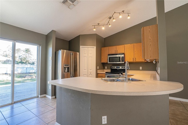 kitchen with visible vents, a peninsula, light tile patterned flooring, light countertops, and appliances with stainless steel finishes