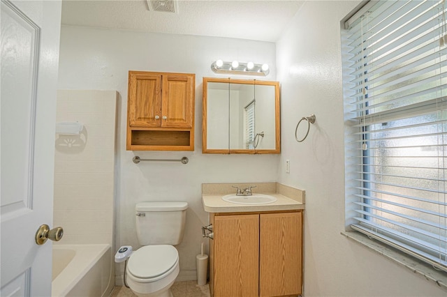 full bathroom featuring vanity, toilet, visible vents, and a textured ceiling