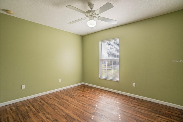 unfurnished room featuring ceiling fan, wood finished floors, baseboards, and a textured ceiling