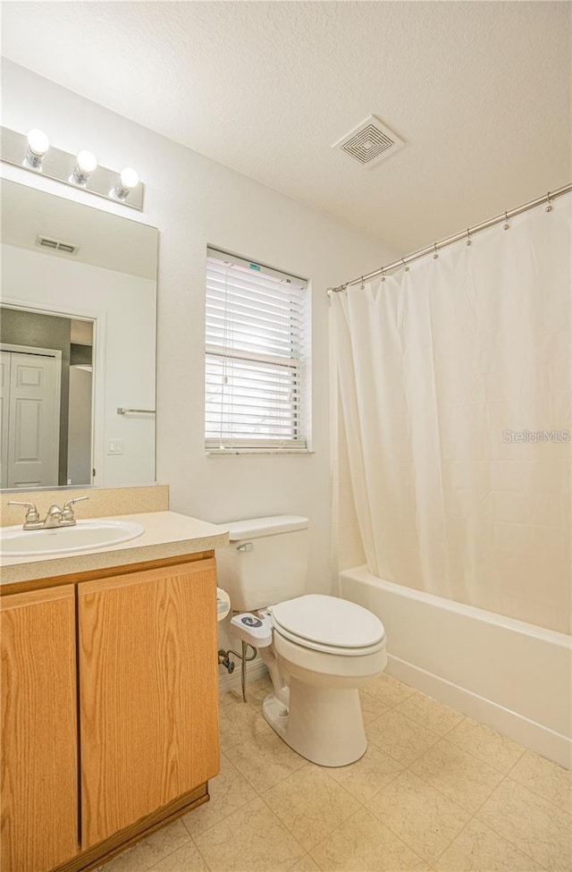 bathroom featuring vanity, tile patterned floors, toilet, and visible vents