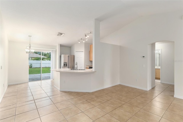 9 Hemlock Run, Ocala, FL 34472 - unfurnished living room with light tile patterned floors, a chandelier, arched walkways, track lighting, and vaulted ceiling