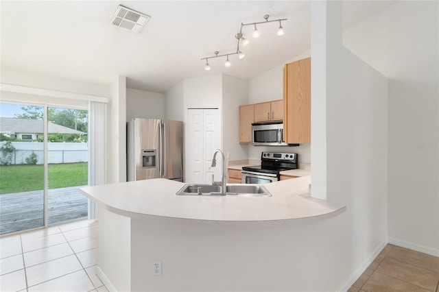 9 Hemlock Run, Ocala, FL 34472 - kitchen with stainless steel appliances, light tile patterned floors, light countertops, a peninsula, and light brown cabinets