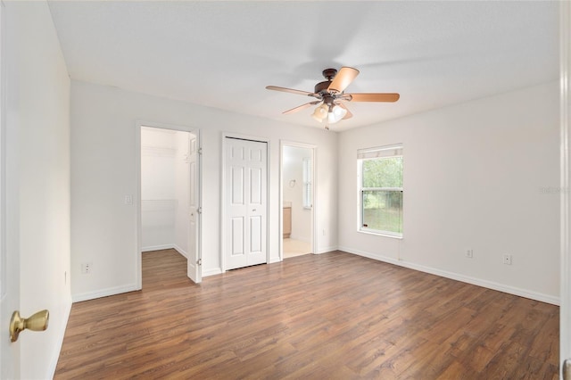 9 Hemlock Run, Ocala, FL 34472 - unfurnished bedroom featuring wood finished floors, connected bathroom, a ceiling fan, and a closet
