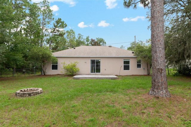 9 Hemlock Run, Ocala, FL 34472 - rear view of house with a fire pit, stucco siding, and a shingled roof
