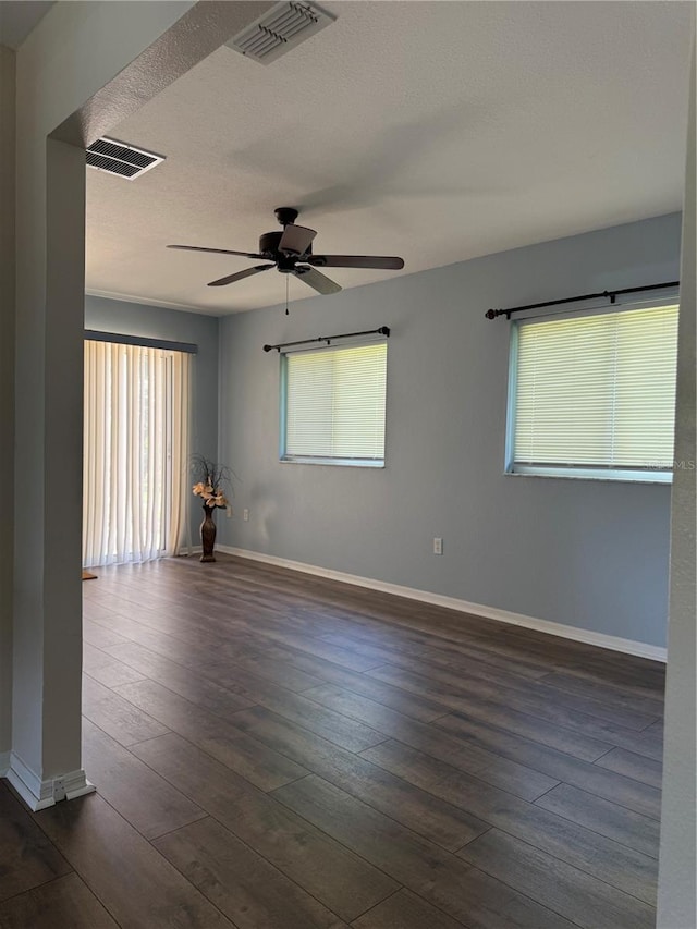 9090 SE 135th Loop, Summerfield, FL 34491 - spare room featuring ceiling fan, dark wood-style floors, baseboards, and a textured ceiling