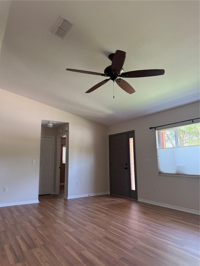9090 SE 135th Loop, Summerfield, FL 34491 - spare room with wood finished floors, ceiling fan, baseboards, and a textured ceiling