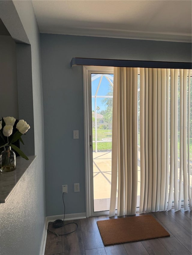 9090 SE 135th Loop, Summerfield, FL 34491 - doorway featuring wood-type flooring, baseboards, and crown molding