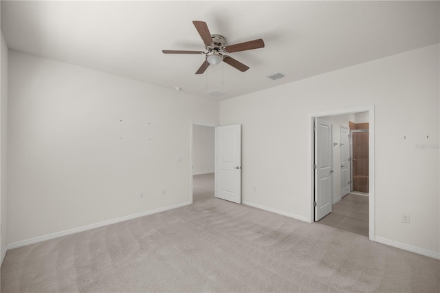 unfurnished bedroom featuring baseboards, visible vents, and light colored carpet